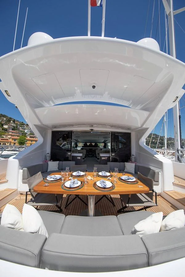 a large white tent with a table and chairs in front of it aboard YALLA Yacht for Sale
