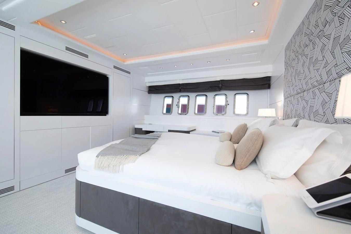 a bedroom with a bed and a tv aboard YALLA Yacht for Sale