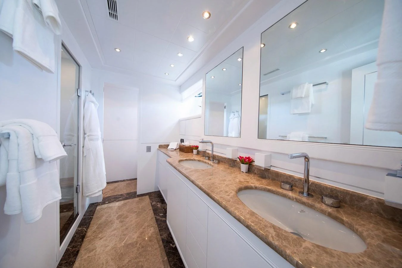 a bathroom with a countertop sink and a mirror aboard YALLA Yacht for Sale