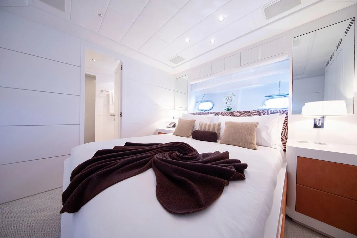 a bedroom with a bed and a desk aboard YALLA Yacht for Sale
