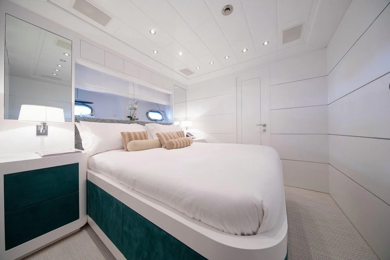 a room with a bed and a mirror aboard YALLA Yacht for Sale