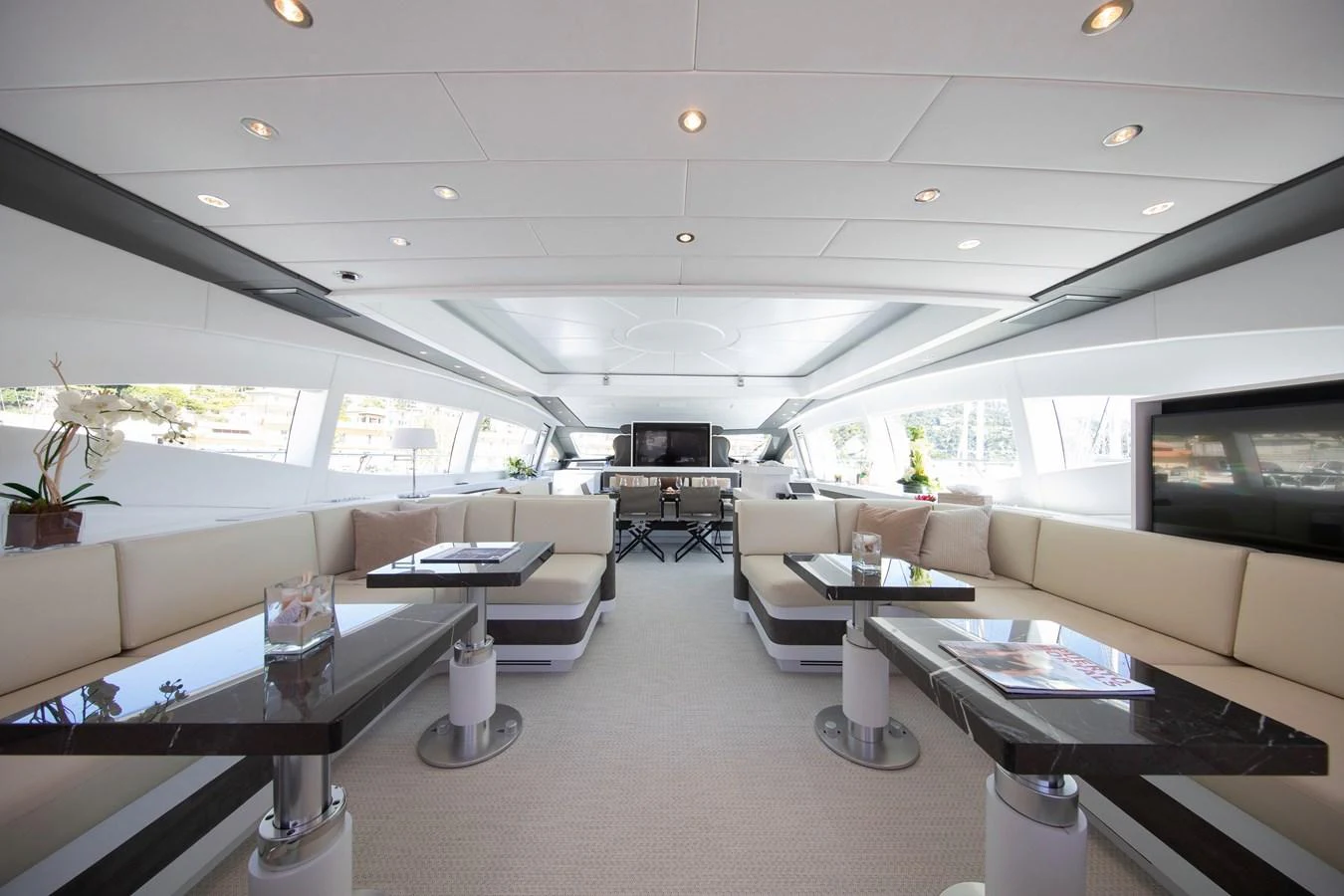 a room with a couch and a table aboard YALLA Yacht for Sale