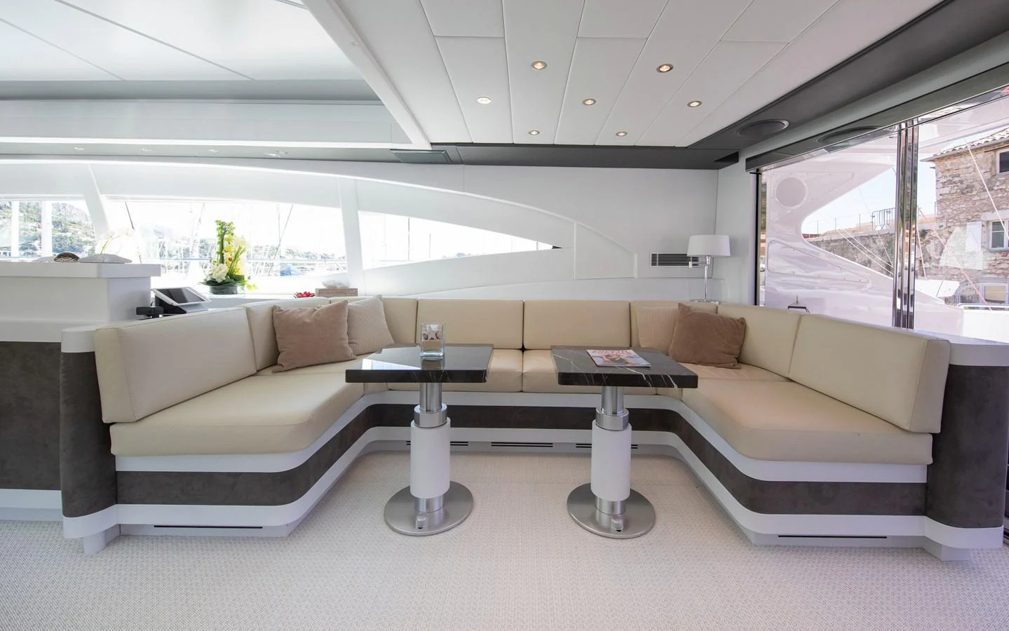 a living room with a couch and a table aboard YALLA Yacht for Sale