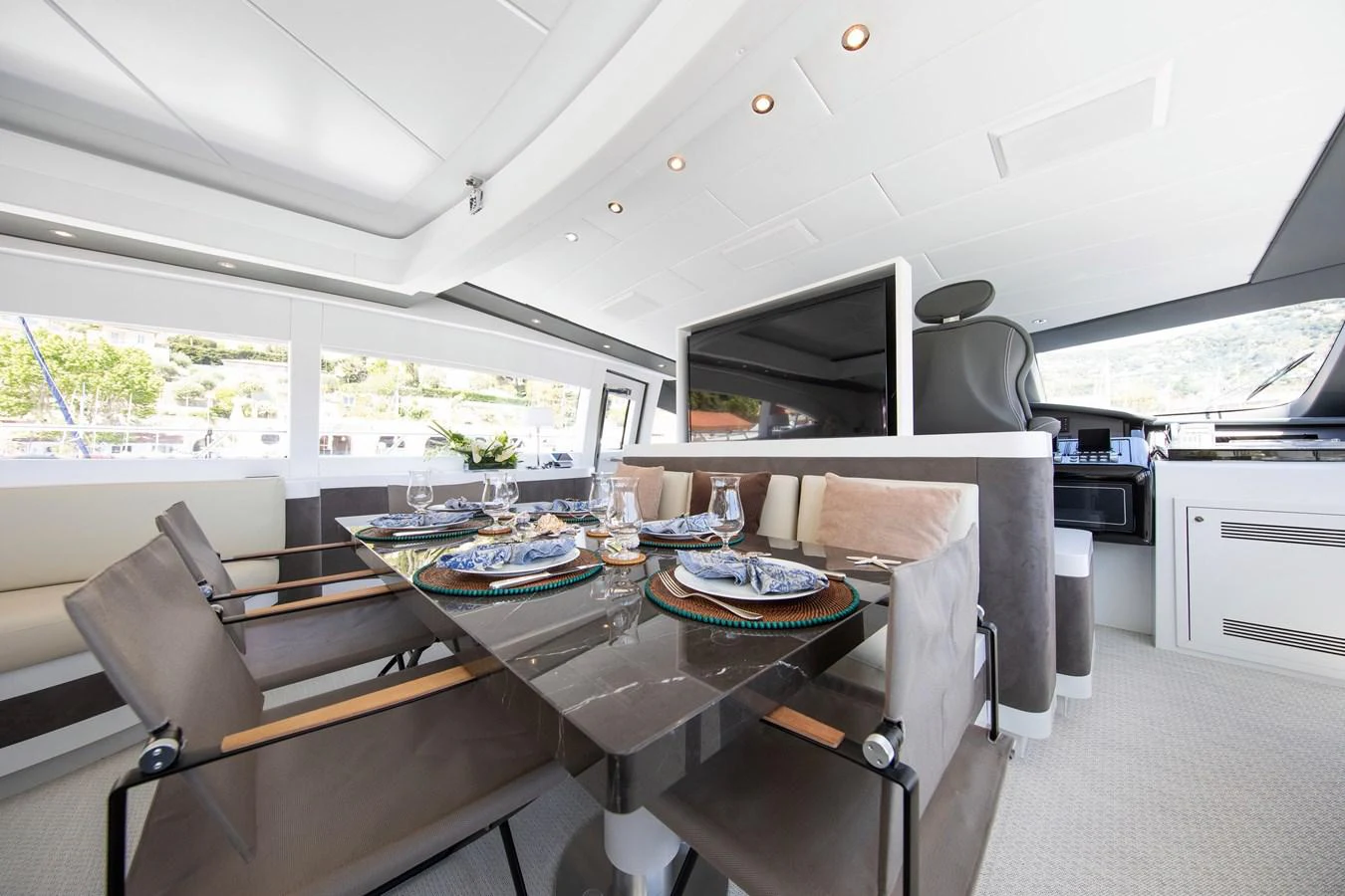 a kitchen with a table and chairs aboard YALLA Yacht for Sale