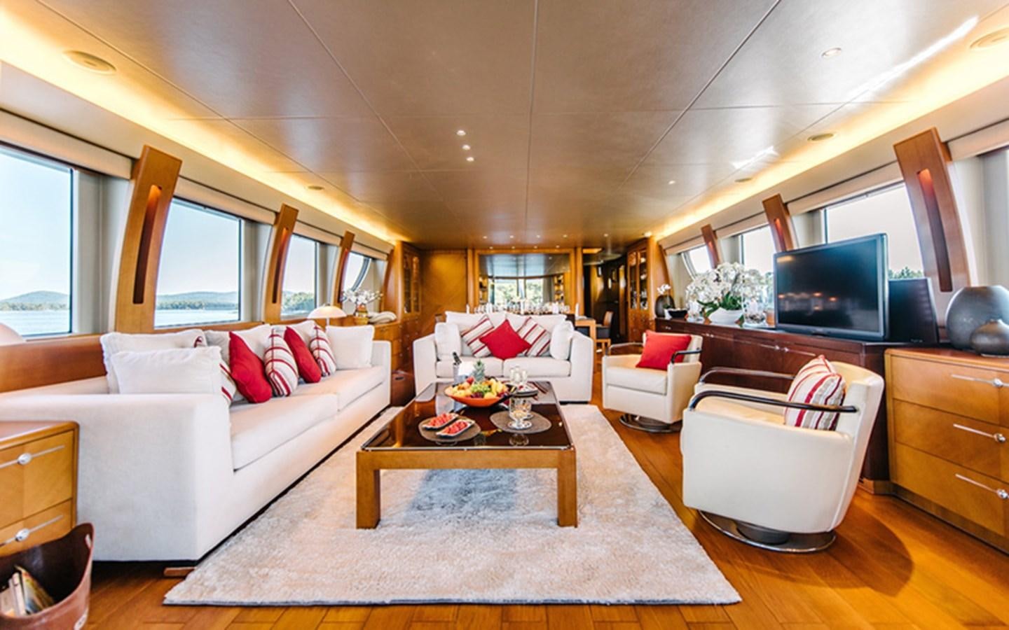 a living room with a large white couch and a television aboard DREAM Yacht for Sale