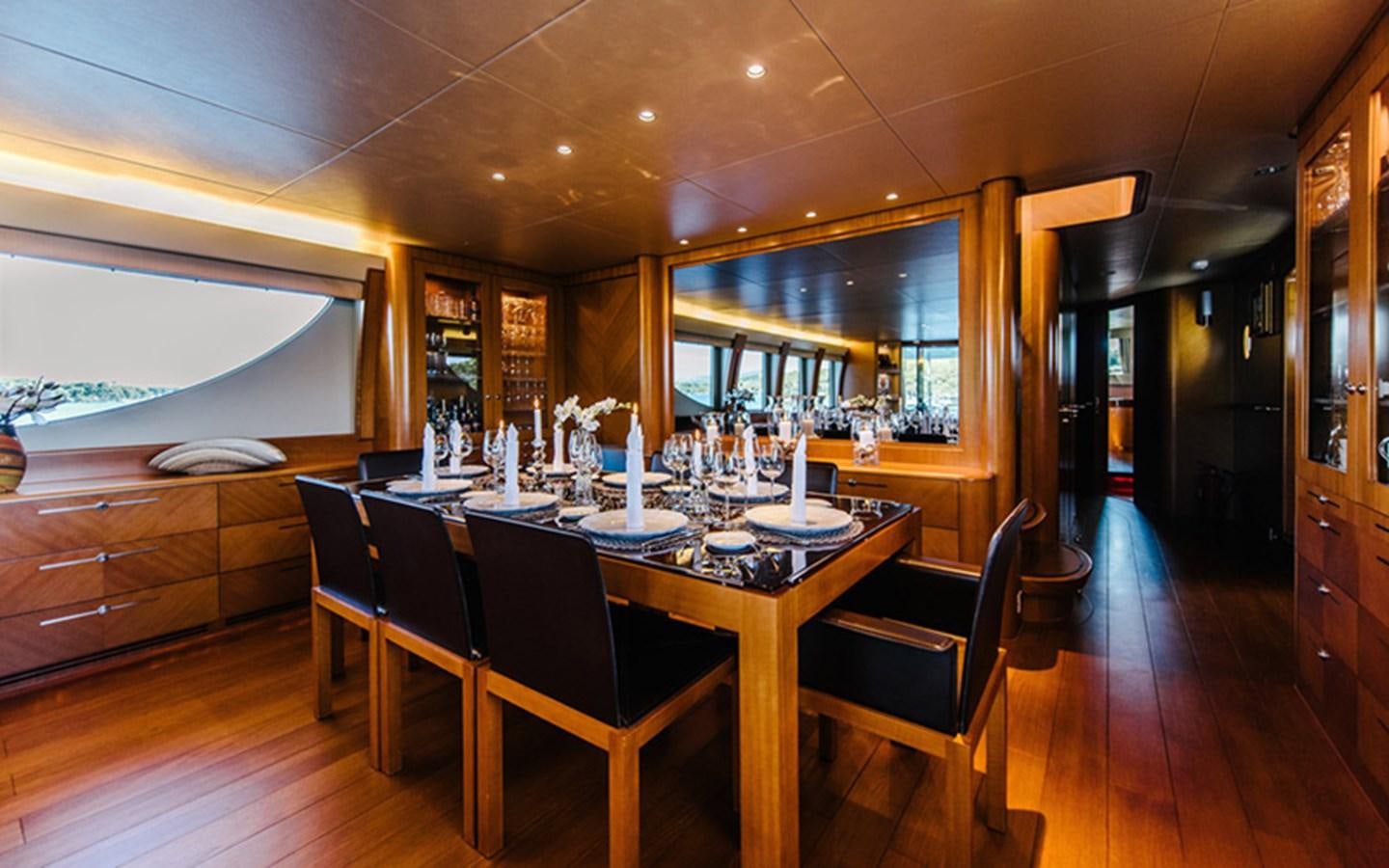 a dining room with a table and chairs aboard DREAM Yacht for Sale