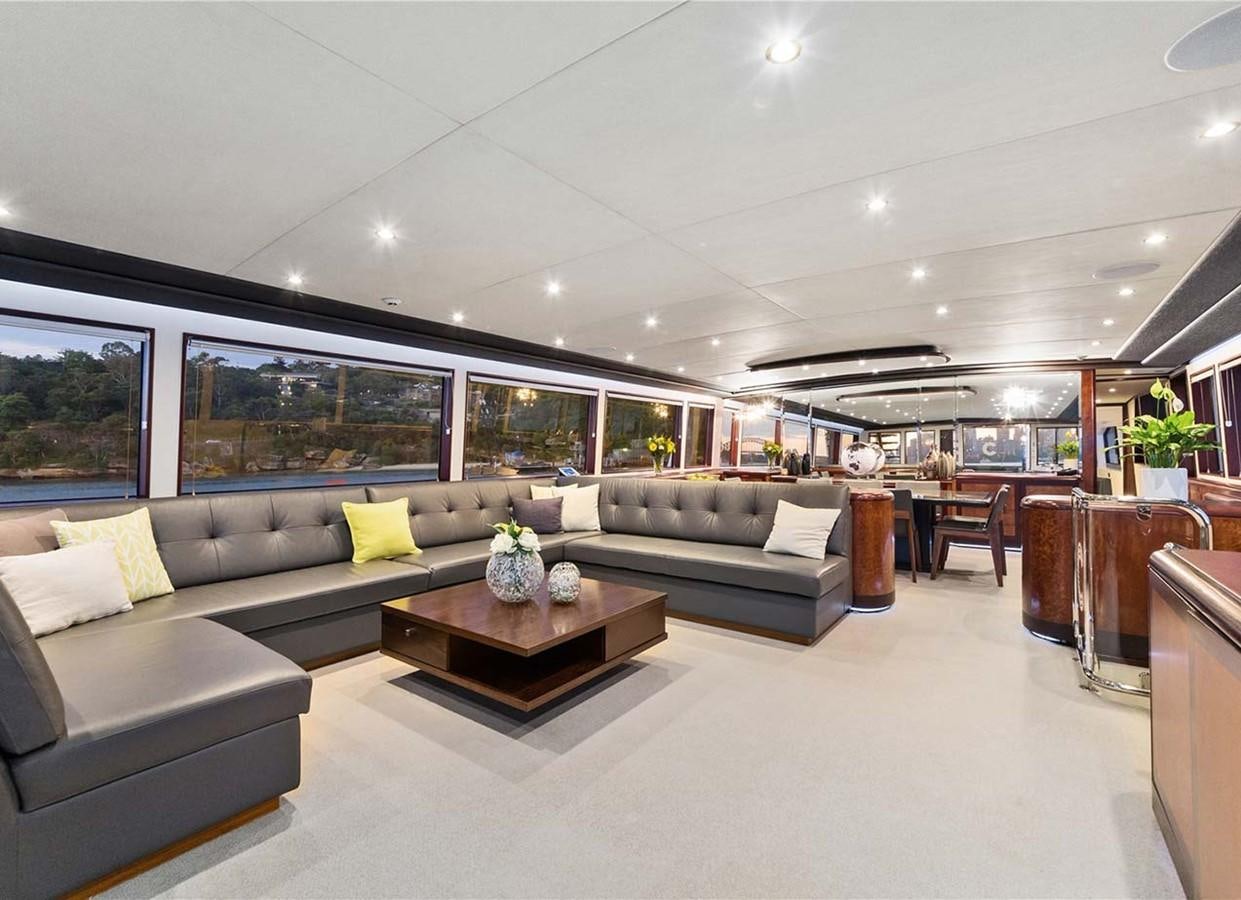 a living room with a couch and a coffee table aboard CORROBOREE Yacht for Sale