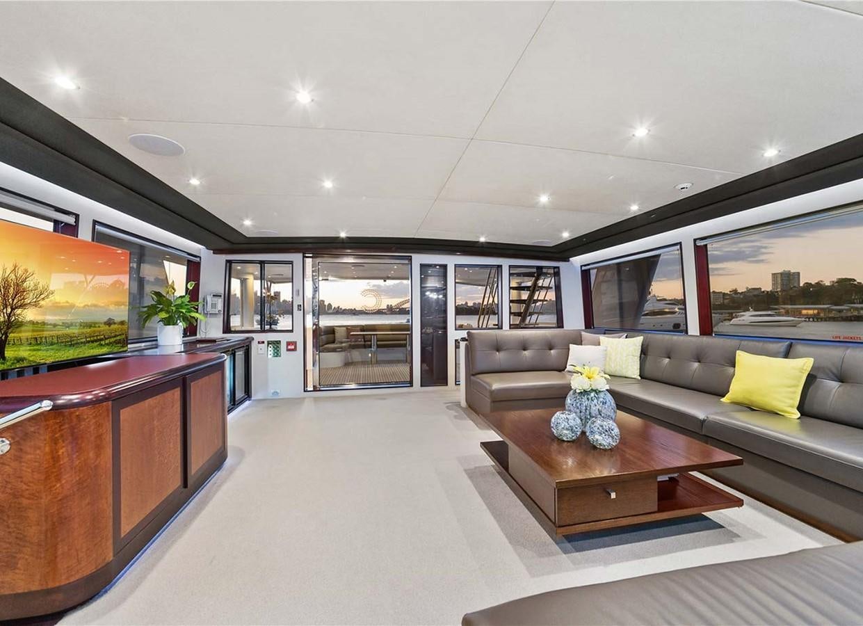 a living room with a couch and a coffee table aboard CORROBOREE Yacht for Sale