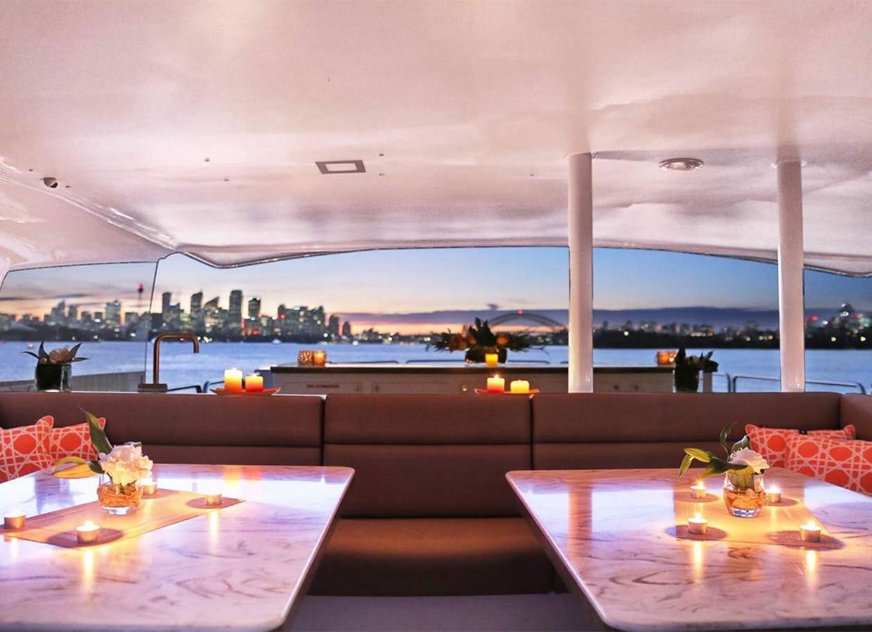 a room with a table and chairs aboard CORROBOREE Yacht for Sale