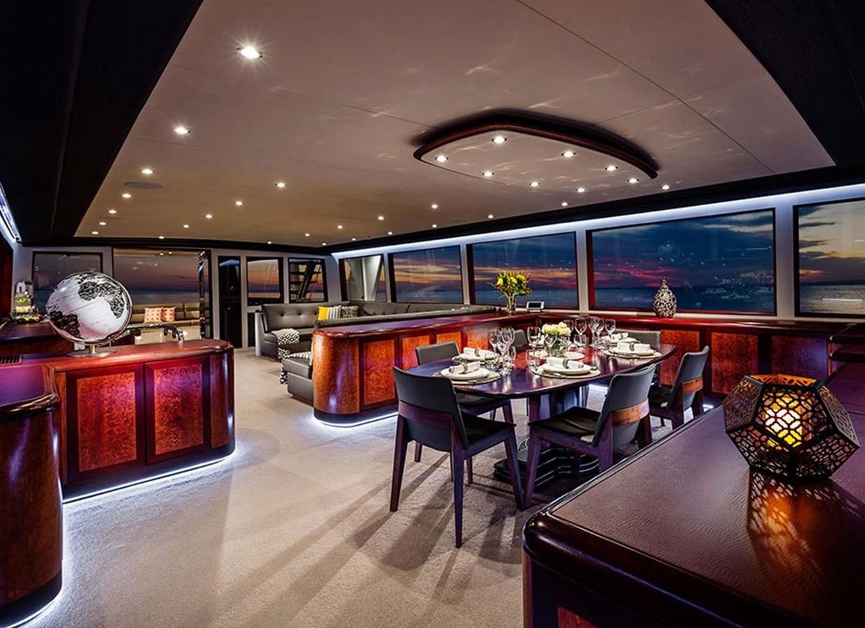 a large room with a table and chairs aboard CORROBOREE Yacht for Sale