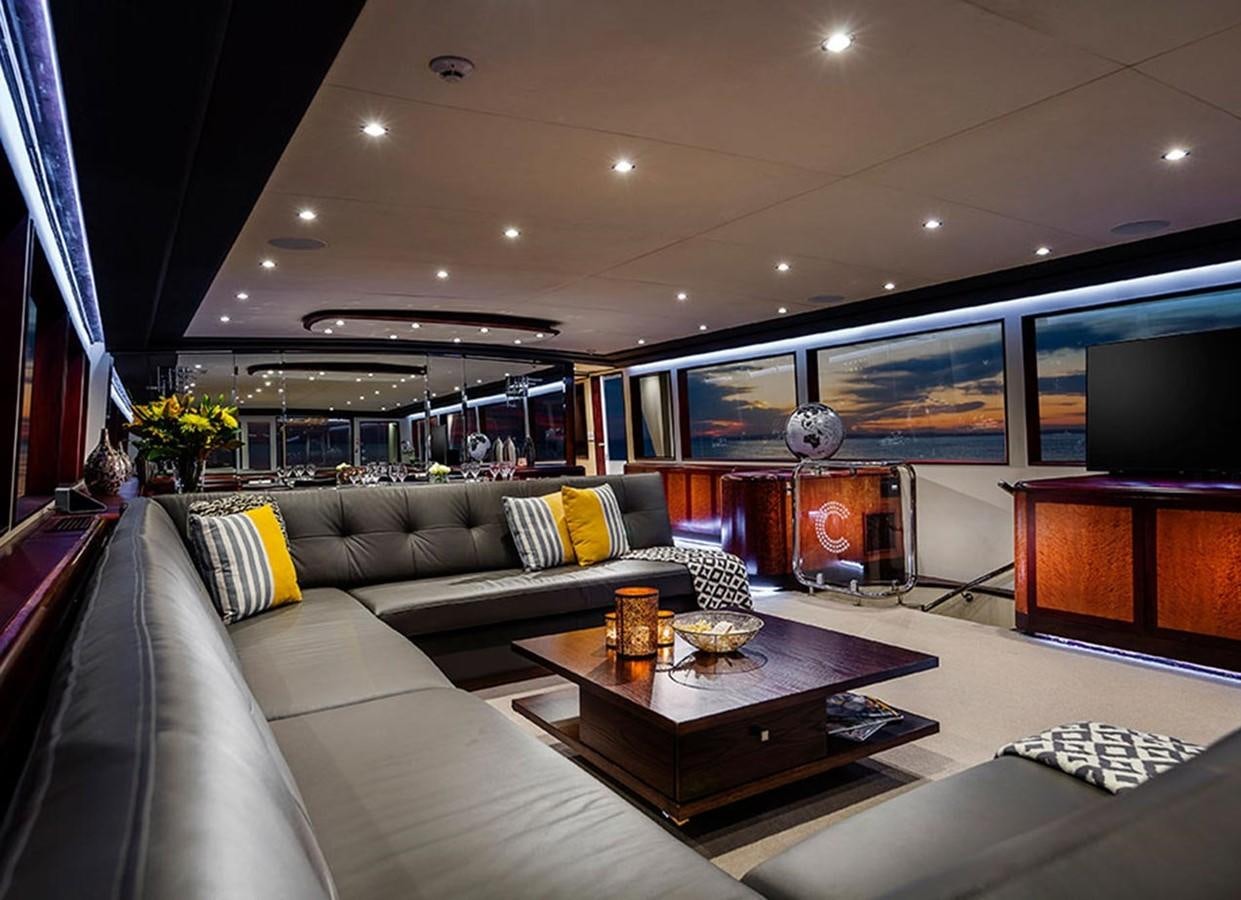 a living room with a fireplace aboard CORROBOREE Yacht for Sale