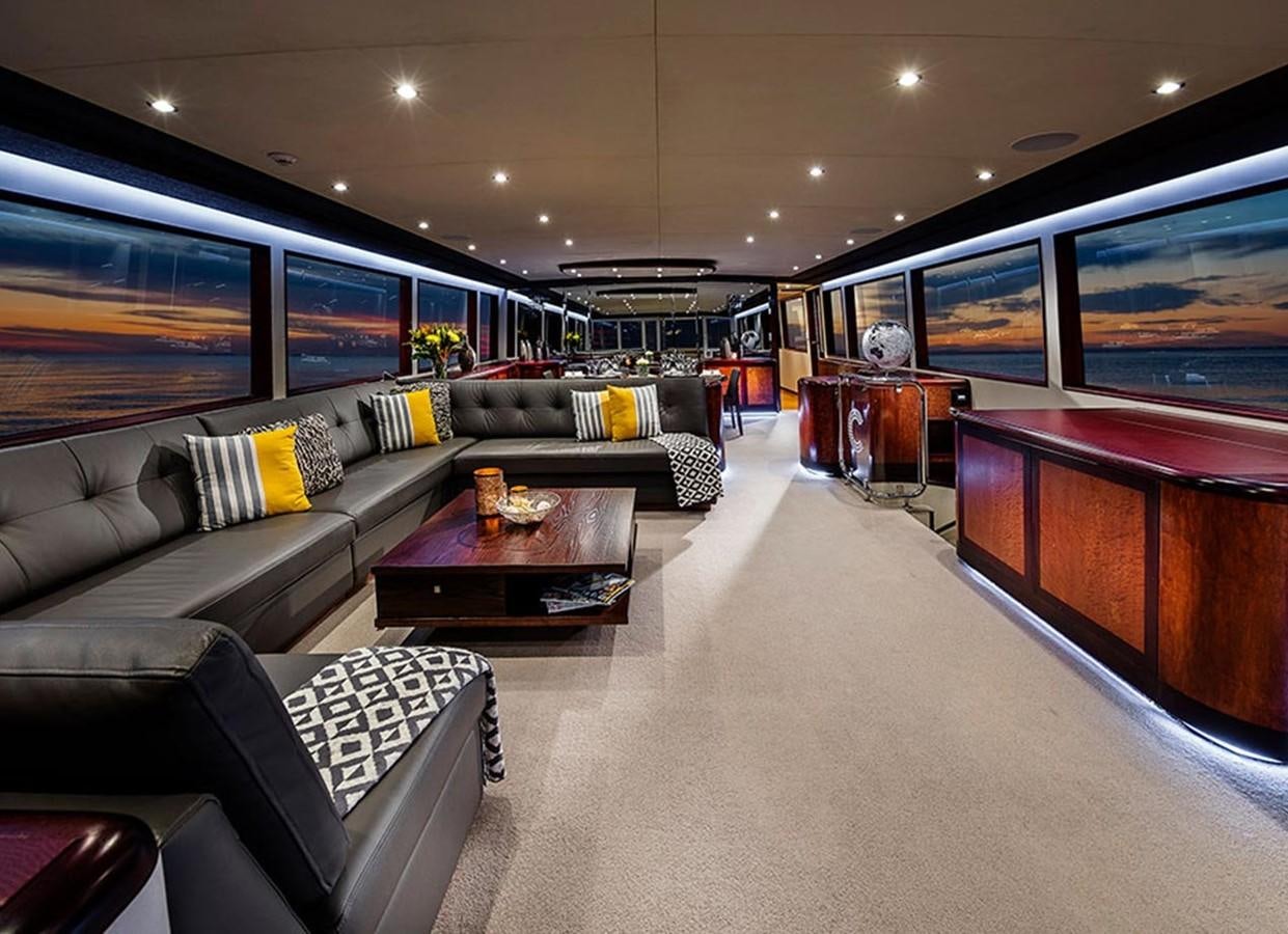 a living room with a couch and a tv aboard CORROBOREE Yacht for Sale
