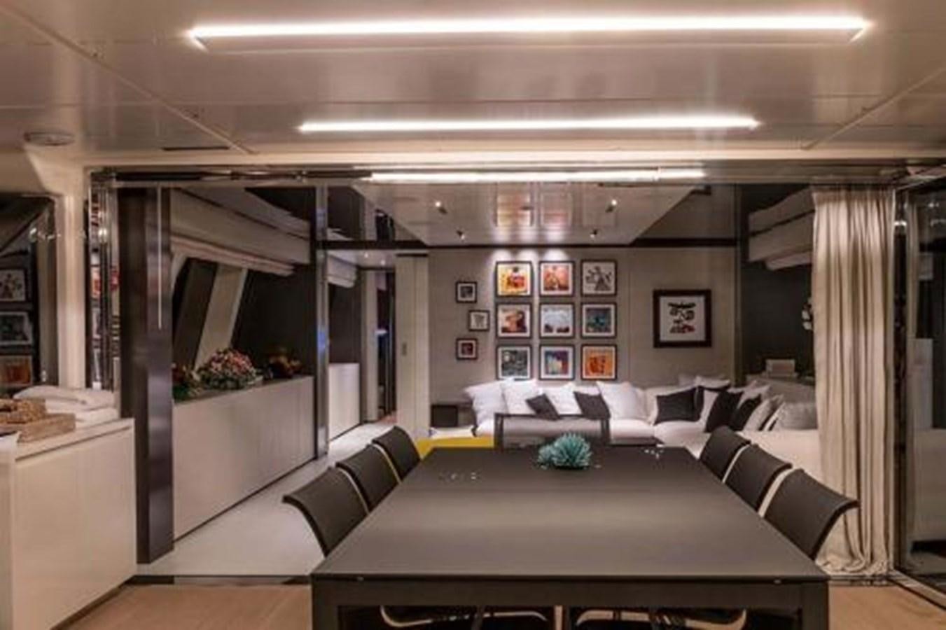 a room with a table and couches aboard DECEMBER SIX Yacht for Sale