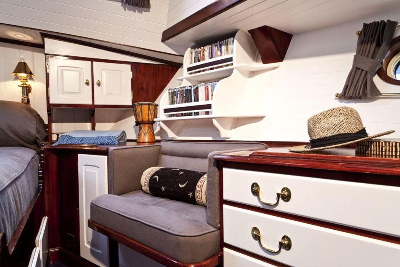 a bedroom with a bed and a desk aboard TIGERLILY OF CORNWALL Yacht for Sale
