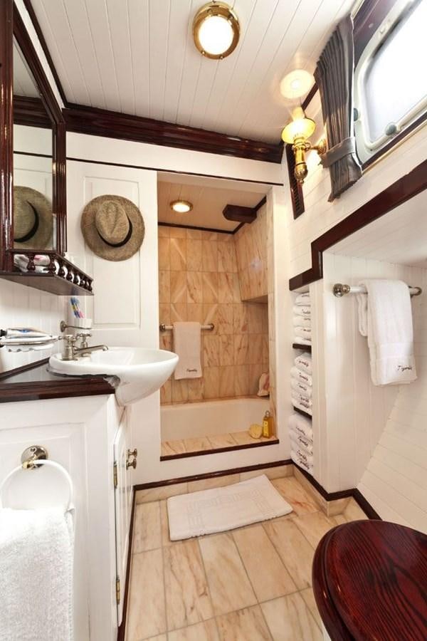 a bathroom with a sink and a bathtub aboard TIGERLILY OF CORNWALL Yacht for Sale