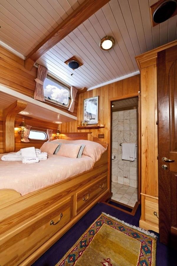 a bedroom with a bed and a door aboard TIGERLILY OF CORNWALL Yacht for Sale