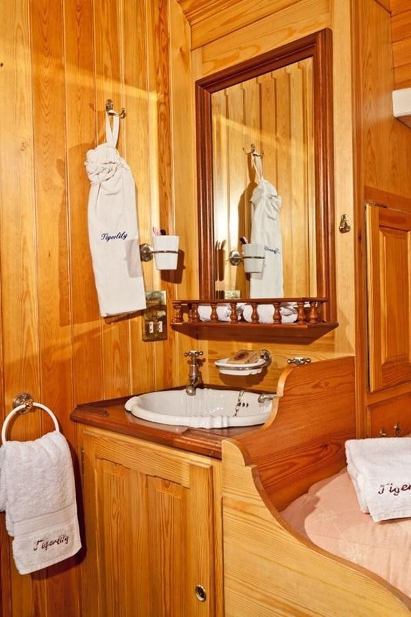 a bathroom with a large mirror aboard TIGERLILY OF CORNWALL Yacht for Sale