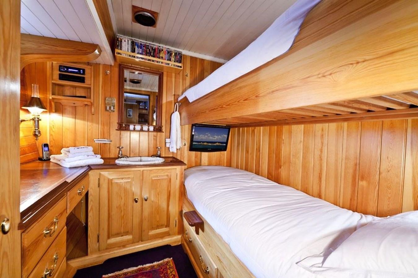 a cabin with a bed and a sink aboard TIGERLILY OF CORNWALL Yacht for Sale