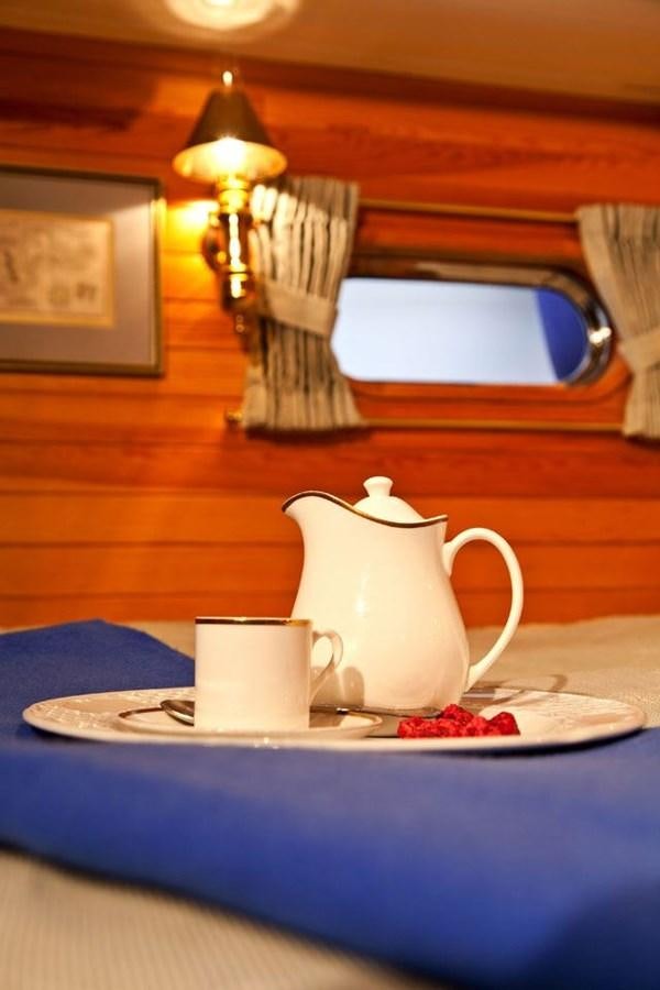 a teapot and a cup on a table aboard TIGERLILY OF CORNWALL Yacht for Sale