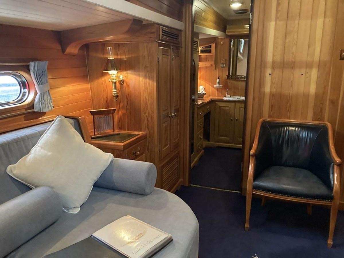 a room with a bed and a chair aboard TIGERLILY OF CORNWALL Yacht for Sale