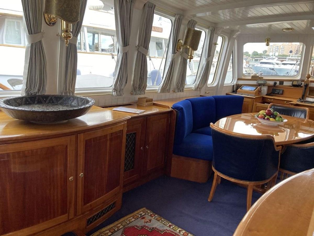 a kitchen with a table and chairs aboard TIGERLILY OF CORNWALL Yacht for Sale
