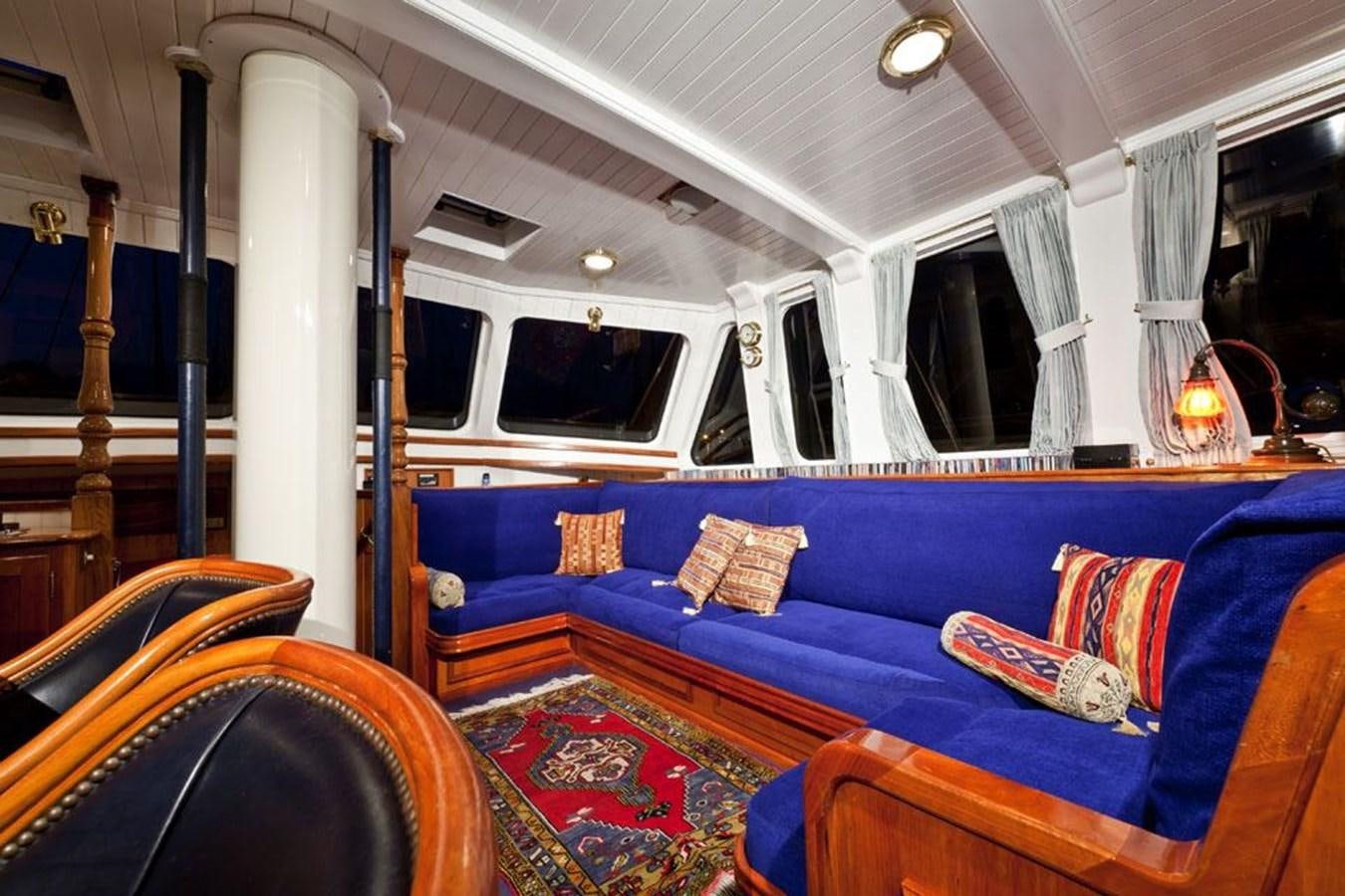a boat with a blue couch aboard TIGERLILY OF CORNWALL Yacht for Sale