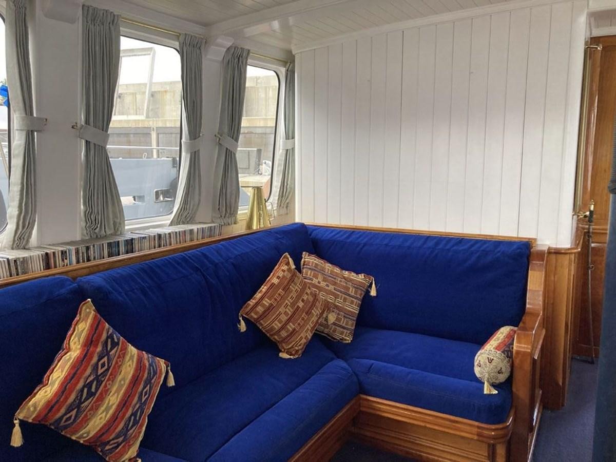 a blue couch in a room aboard TIGERLILY OF CORNWALL Yacht for Sale
