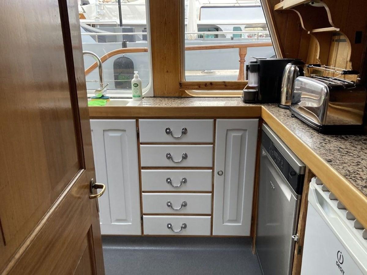 a kitchen with a sink and cabinets aboard TIGERLILY OF CORNWALL Yacht for Sale