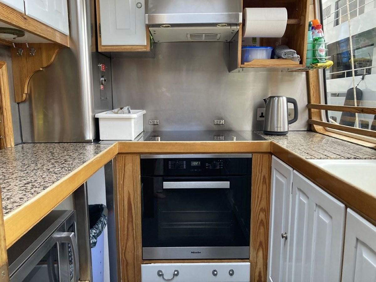 a kitchen with a microwave oven and a coffee maker aboard TIGERLILY OF CORNWALL Yacht for Sale