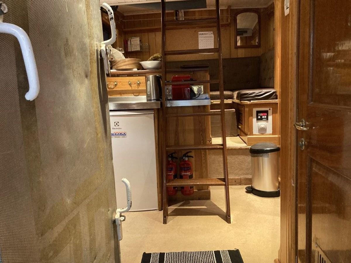 a room with a shelf and a refrigerator aboard TIGERLILY OF CORNWALL Yacht for Sale