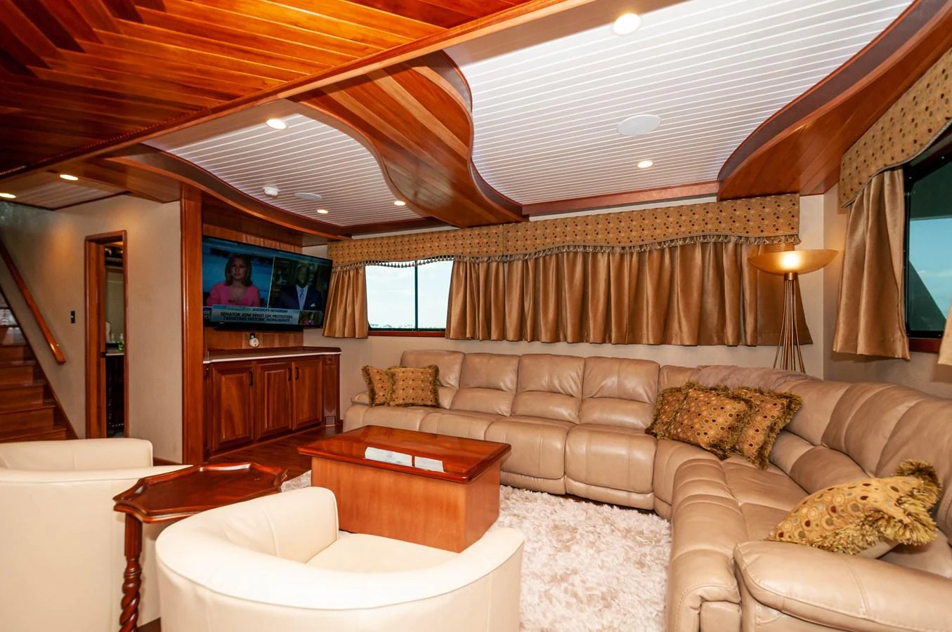 a living room with a large television aboard LE COLBY JEAN Yacht for Sale