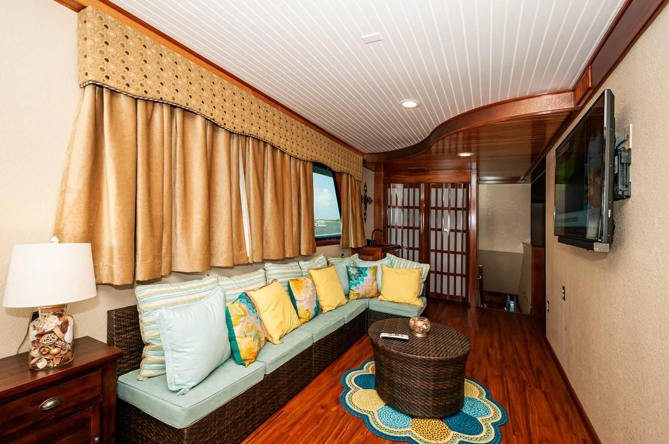 a bedroom with a bed and a television aboard LE COLBY JEAN Yacht for Sale