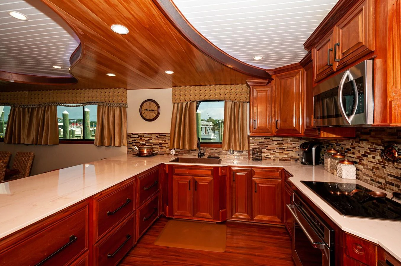 a kitchen with wooden cabinets aboard LE COLBY JEAN Yacht for Sale