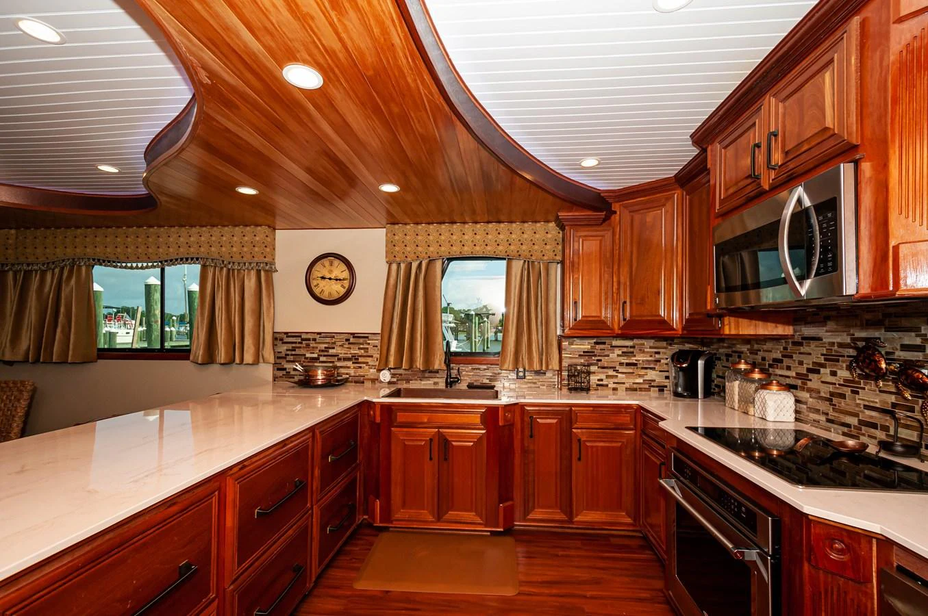 a kitchen with wooden cabinets aboard LE COLBY JEAN Yacht for Sale