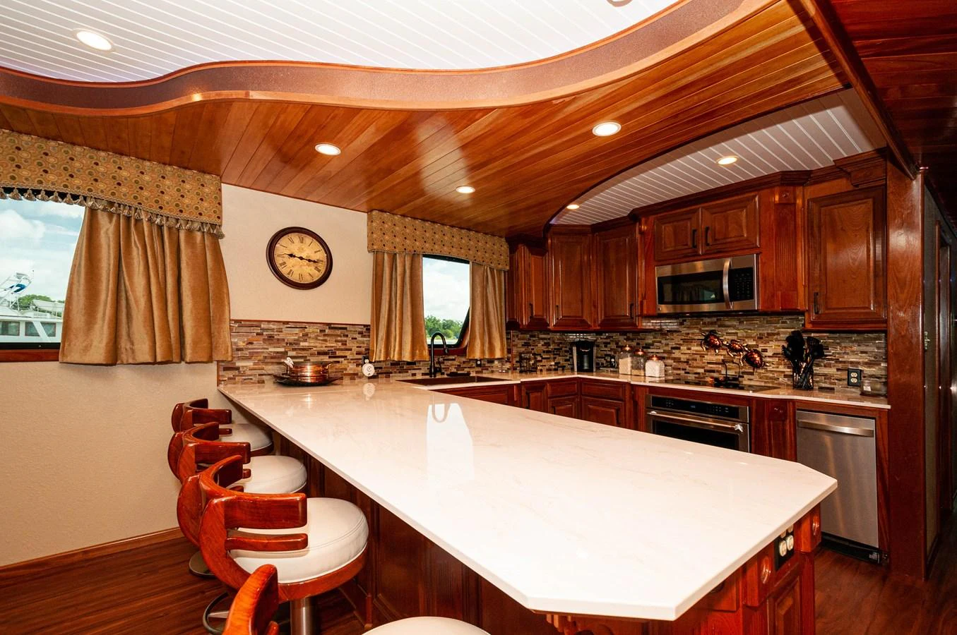 a kitchen with a large island aboard LE COLBY JEAN Yacht for Sale