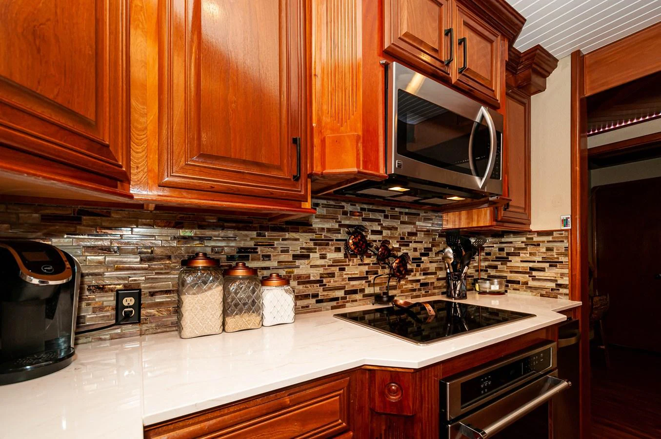 a kitchen with wooden cabinets aboard LE COLBY JEAN Yacht for Sale