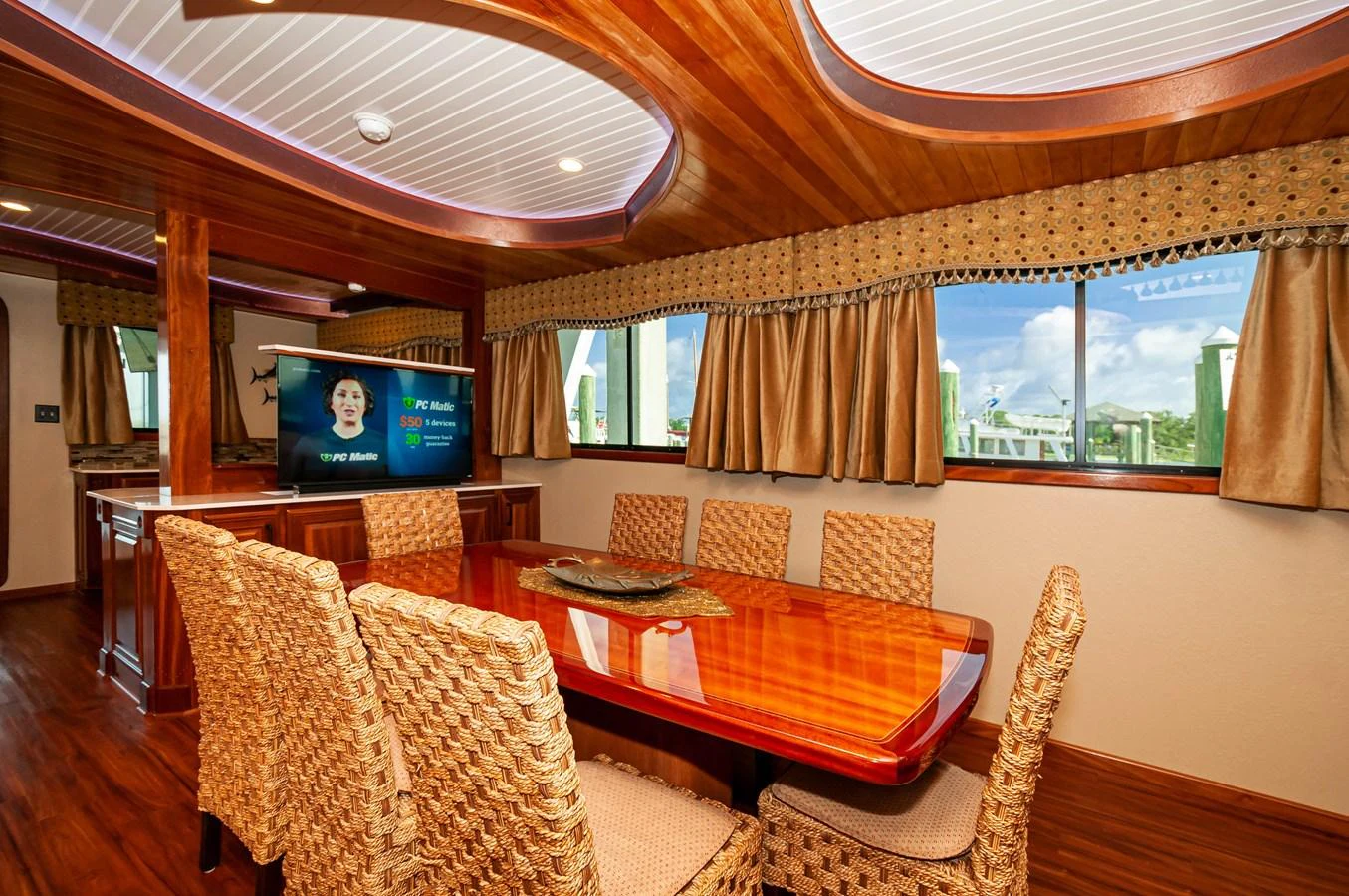 a living room with a table and chairs aboard LE COLBY JEAN Yacht for Sale