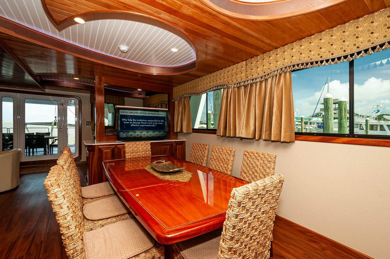 a living room with a table and chairs aboard LE COLBY JEAN Yacht for Sale