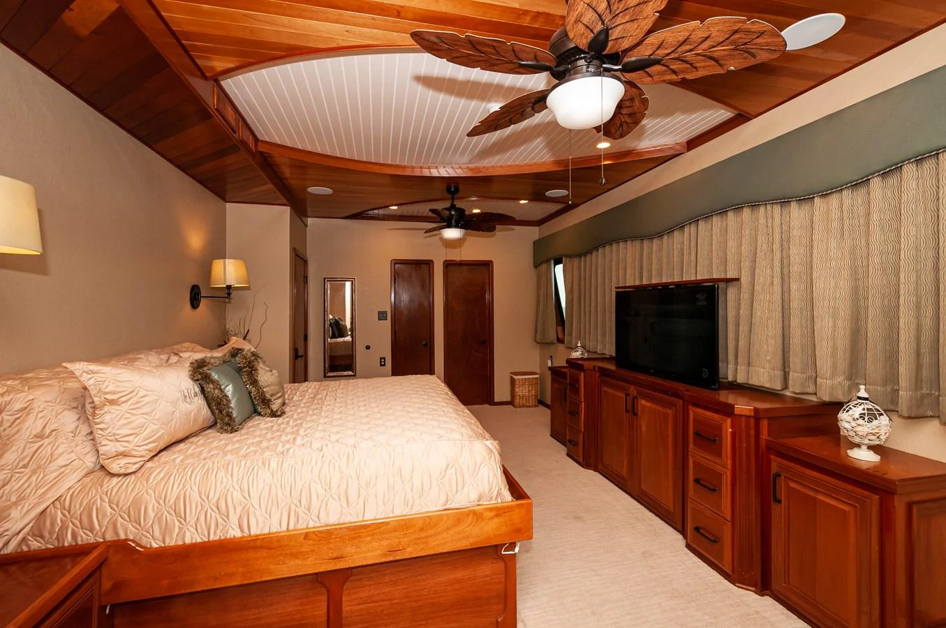 a bedroom with a bed and a television aboard LE COLBY JEAN Yacht for Sale