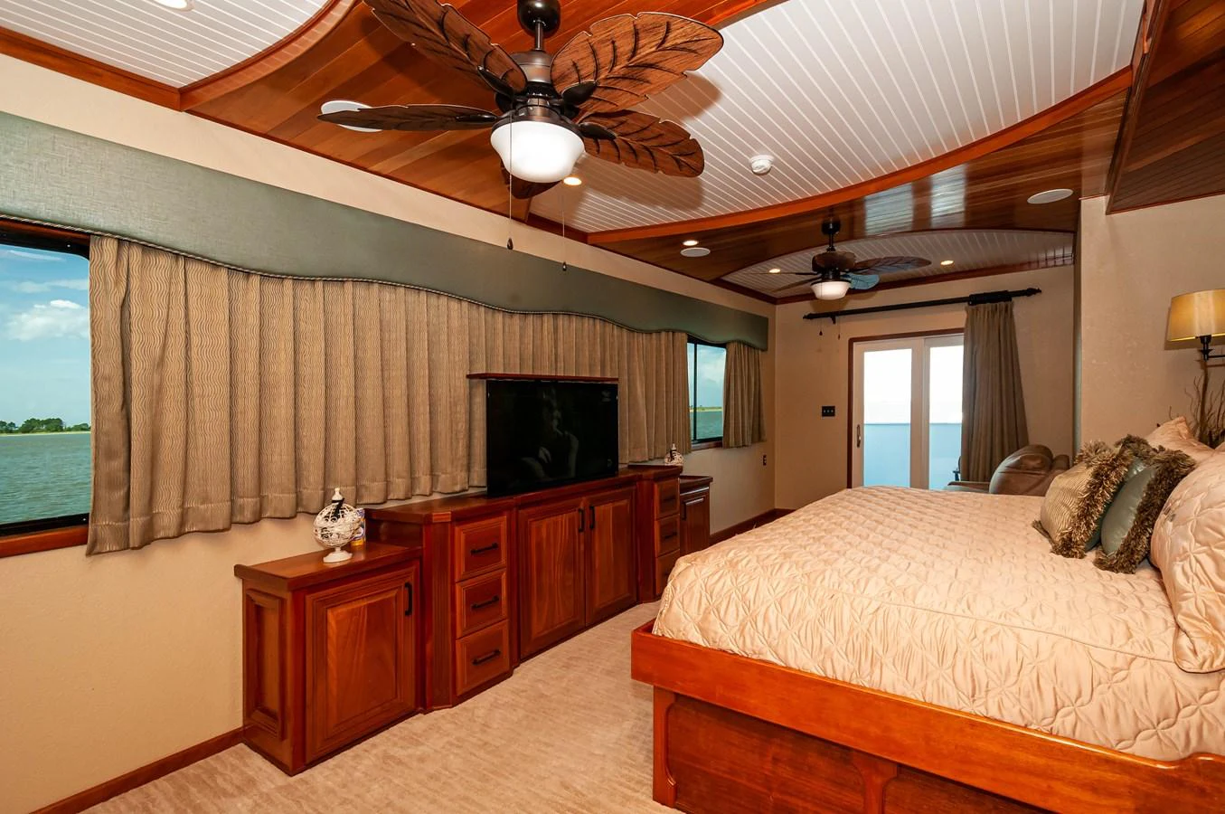 a bedroom with a bed and a television aboard LE COLBY JEAN Yacht for Sale