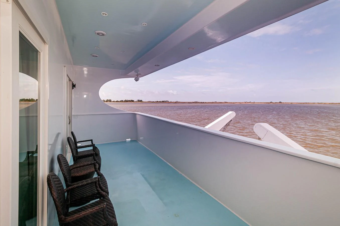a balcony overlooking a beach aboard LE COLBY JEAN Yacht for Sale