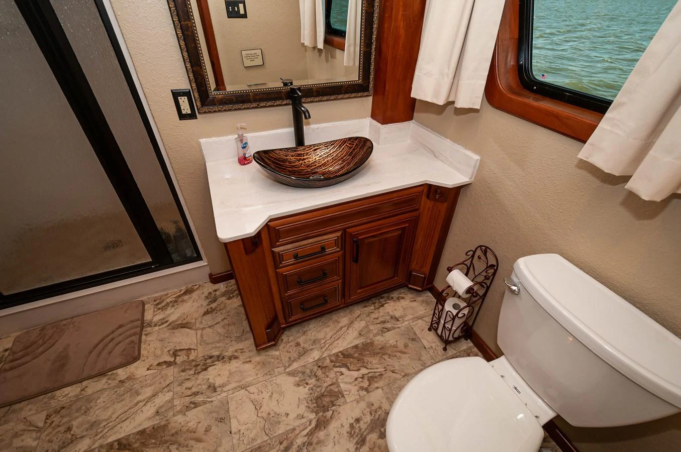 a bathroom with a sink and toilet aboard LE COLBY JEAN Yacht for Sale