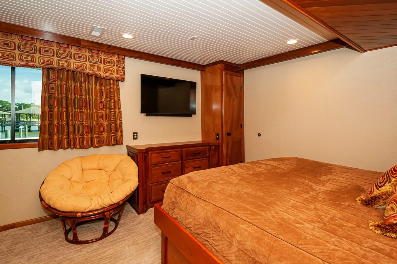 a bedroom with a bed and a tv on the wall aboard LE COLBY JEAN Yacht for Sale