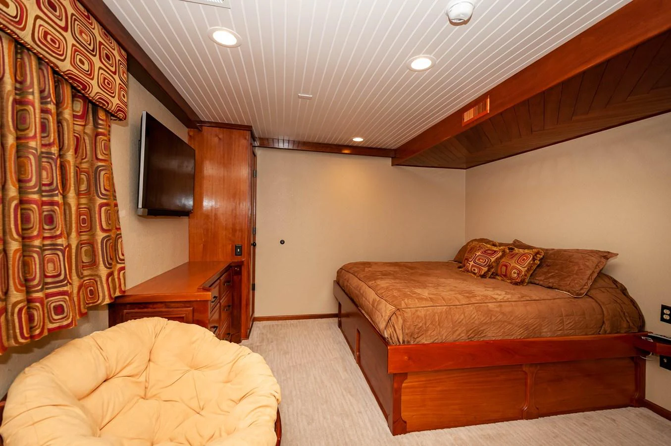 a bedroom with a bed and a tv on the wall aboard LE COLBY JEAN Yacht for Sale