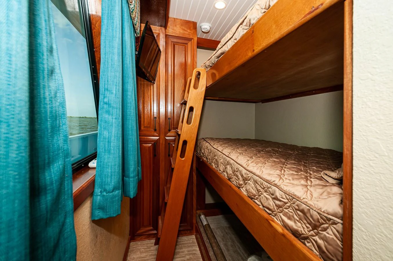 a room with bunk beds aboard LE COLBY JEAN Yacht for Sale