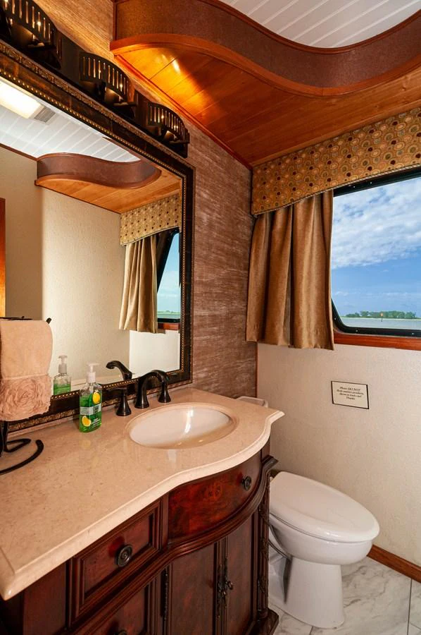 a bathroom with a sink and a toilet aboard LE COLBY JEAN Yacht for Sale