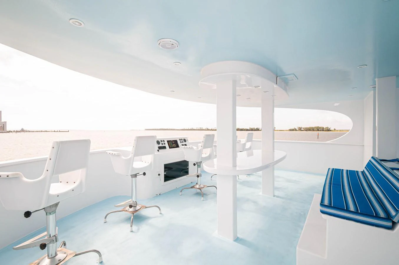 a room with a table chairs and a large white umbrella aboard LE COLBY JEAN Yacht for Sale