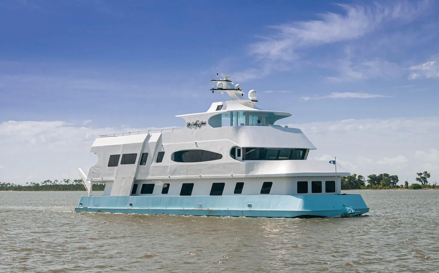 a white boat on a beach aboard LE COLBY JEAN Yacht for Sale