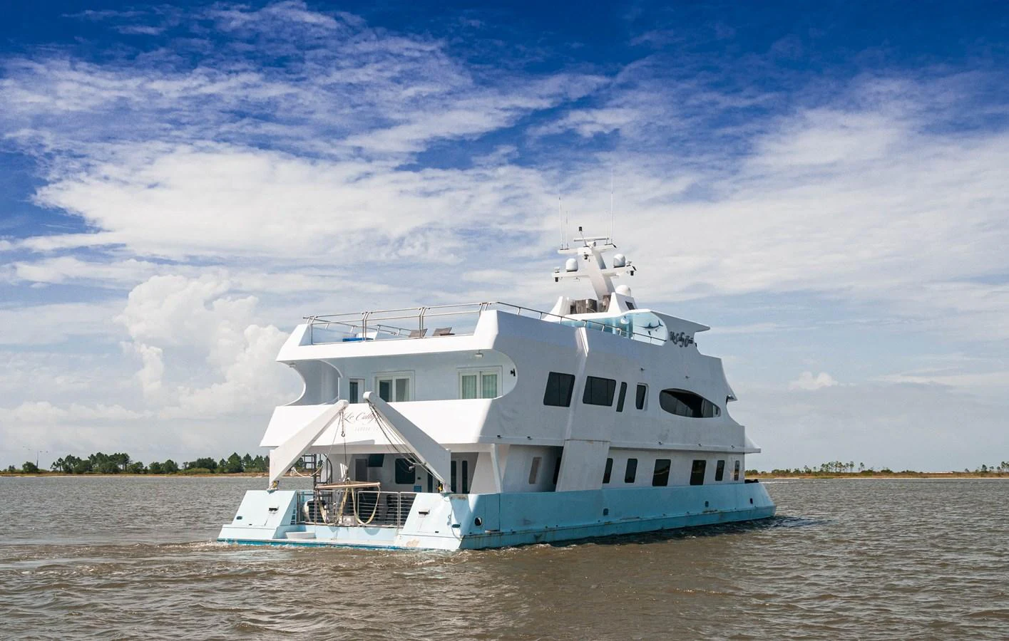 a white boat on a river aboard LE COLBY JEAN Yacht for Sale