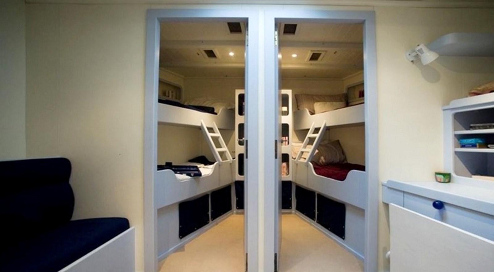 a room with a bunk bed and a desk aboard ABELY Yacht for Sale